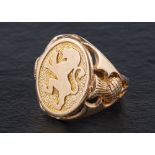 A 9ct gold signet ring depicting the lion rampant of Scotland,: openwork thistles to shoulders,