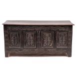 A Jacobean oak coffer, circa 1680,: the hinged cover above an arcaded frieze carved in low relief,