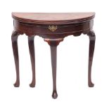 A George II mahogany demi-lune tea table, circa 1740,: with two hinged tops,