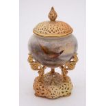 A Royal Worcester porcelain pot pourri jar and pierced cover: the jar supported on three scrolling