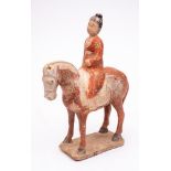 A Chinese funerary equestrian group: modelled with a rider in red robes seated on a white cloth