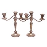 A pair of sterling silver and filled twin branch candelabra,