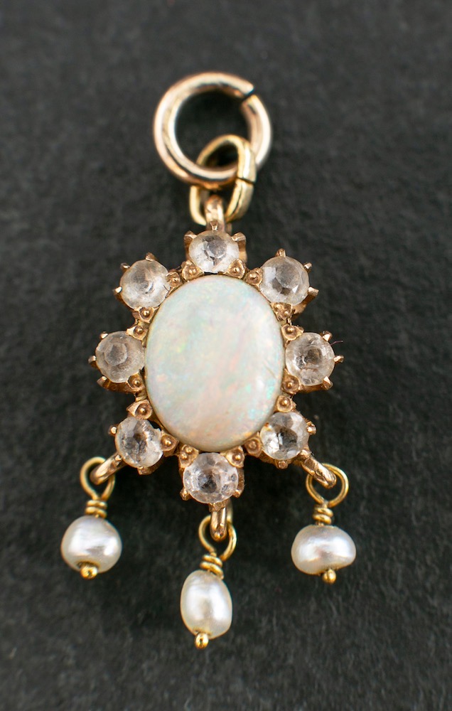 A cabochon-cut opal, white topaz and seed pearl pendant,: estimated opal weight ca. 0.