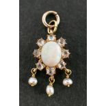 A cabochon-cut opal, white topaz and seed pearl pendant,: estimated opal weight ca. 0.