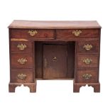 A George II mahogany kneehole desk, circa 1740,