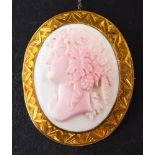 An 18ct gold, Victorian, shell cameo brooch:, depicting Dionysus in profile with grapes in hair,