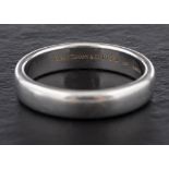 A platinum ring by Tiffany,: signed 'Tiffany & Co', dated 1999 with hallmarks for London, 2005,