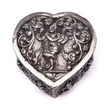 An Indian silver casket and cover: of heart-shaped outline, the domed lid decorated with a dancer,