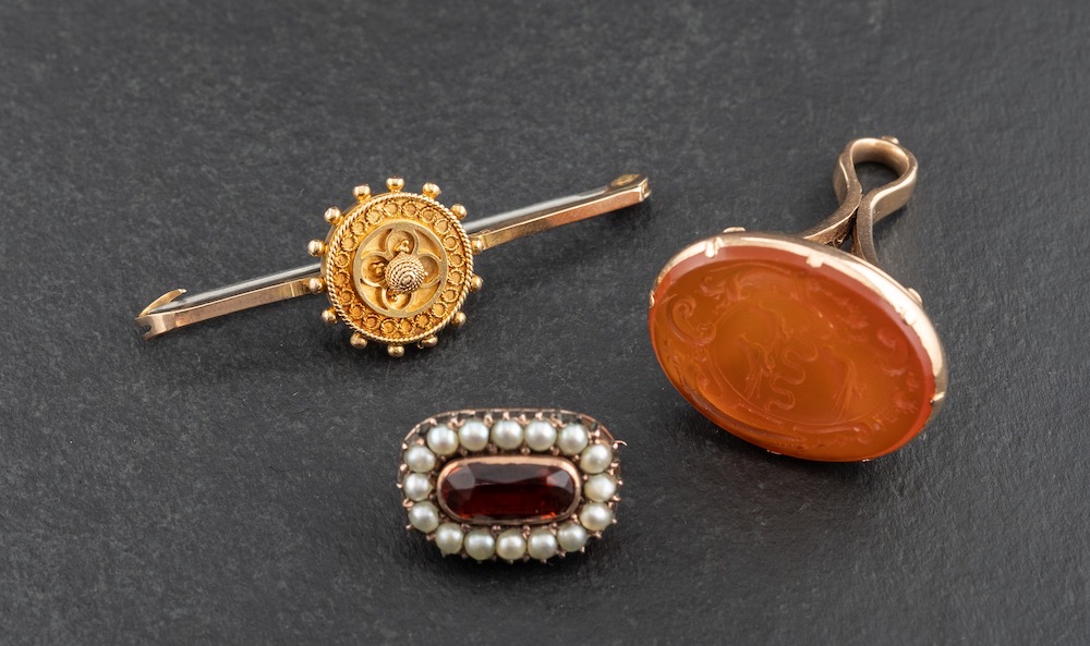 Two brooches and a seal fob,: including an Etruscan revival style brooch, stamped '9C', length ca.