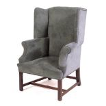 A teal upholstered wing armchair in George II style, late 19th /early 20th century,