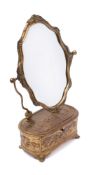 A 19th Century French gilt metal toilet mirror: the cartouche-shaped bevelled mirror plate on