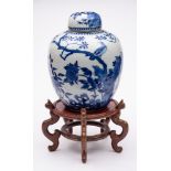 A Chinese porcelain oviform jar and cover: painted in blue with birds amongst peony and pierced