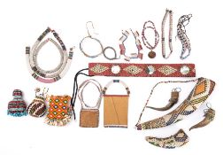 A collection of bead work items: includes belt with cowry shell panels, gourd covered with beads,