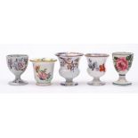 A group of five 19th Century pottery egg cups: including a Wemyss cup painted with pink cabbage
