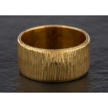 An 18ct gold ring:, with textured surface, hallmarks for London, 1969, ring size Q, total weight ca.