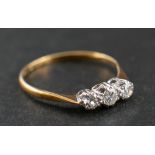 A round, brilliant-cut diamond three-stone ring,: estimated total diamond weight ca. 0.
