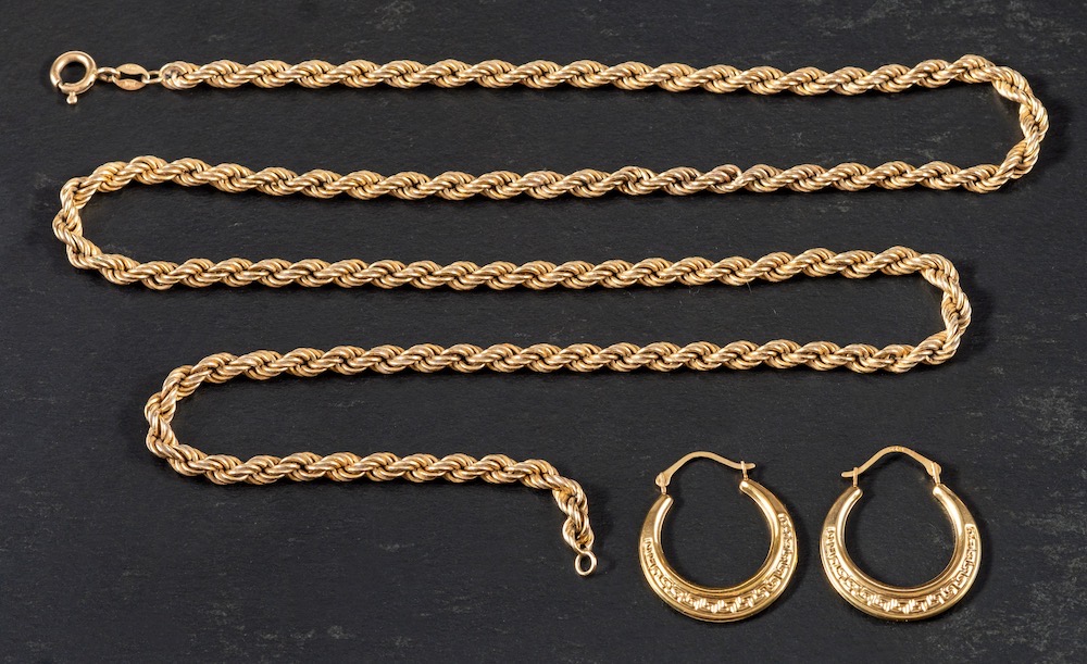 A 9ct gold rope twist necklace and a pair of hoop earrings:,