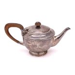 A George V hammered silver bachelor's teapot, maker Albert Edward Jones, Birmingham, 1921: crested,