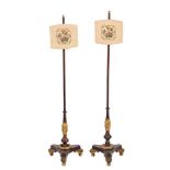 A pair of Regency carved and parcel giltwood pole screens, in the manner of Morel and Seddon,