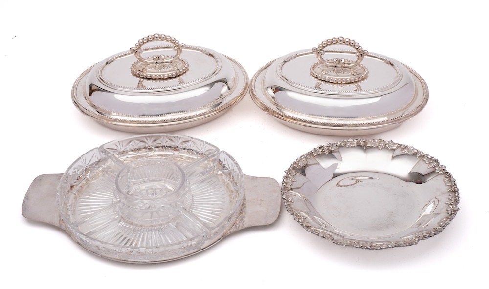 A pair of silver plated entree dishes and covers: of oval outline with beaded borders,