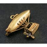 An Airship charm,: with basket and movable propellers, length ca. 2.4cm, total weight ca. 1.6gms.