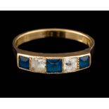A blue stone and white stone ring,: set with alternating square cut blue and white stones,