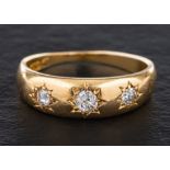 An 18ct gold, old-cut diamond, three-stone ring,: total estimated diamond weight ca. 0.