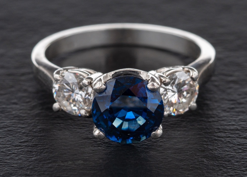 A sapphire and diamond three-stone ring,: calculated sapphire weight ca. 2.