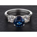 A sapphire and diamond three-stone ring,: calculated sapphire weight ca. 2.