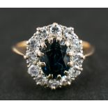 A sapphire and round, brilliant-cut diamond cluster ring,: calculated sapphire weight ca.