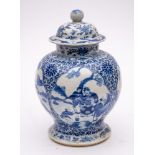 A Chinese blue and white baluster jar and cover: painted with four lotus-shaped panels depicting