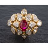 A ruby and diamond cluster ring,: the central oval cut ruby estimated to weigh 1.