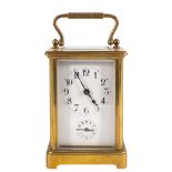 A Victorian French brass carriage alarm clock: the eight-day duration movement having a platform