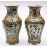 A pair of Chinese Canton famille rose/verte baluster vases: enamelled with shaped panels of figures