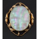 Two oval, gilt metal pendant/ brooches,