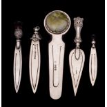 A collection of five assorted silver book marks,