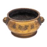 A large Chinese dated bronze censer: of compressed bombe form with mythical beast-head handles and