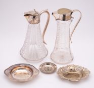 An electro-plated three-piece teaset: a clear glass and plate mounted claret jug,