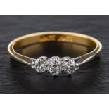 A round, brilliant-cut diamond three-stone ring,: total estimated diamond weight ca. 0.