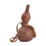 A double gourd water container: of natural form, 34cm high.