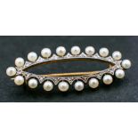 A navette-shaped brooch to cultured pearls and rose-cut diamond surround,