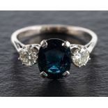 An oval mixed-cut sapphire and round, brilliant-cut diamond, three-stone ring,