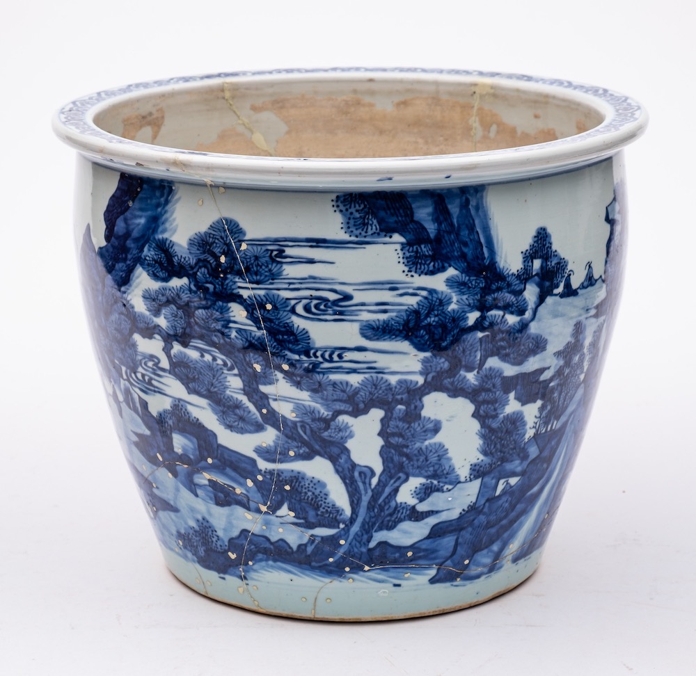 A large Chinese blue and white 'landscape' jardiniere: the exterior painted overall with figures,