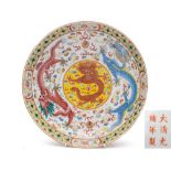 Two Chinese famille rose 'Dragon' dishes: decorated in bright enamels with dragons chasing flaming
