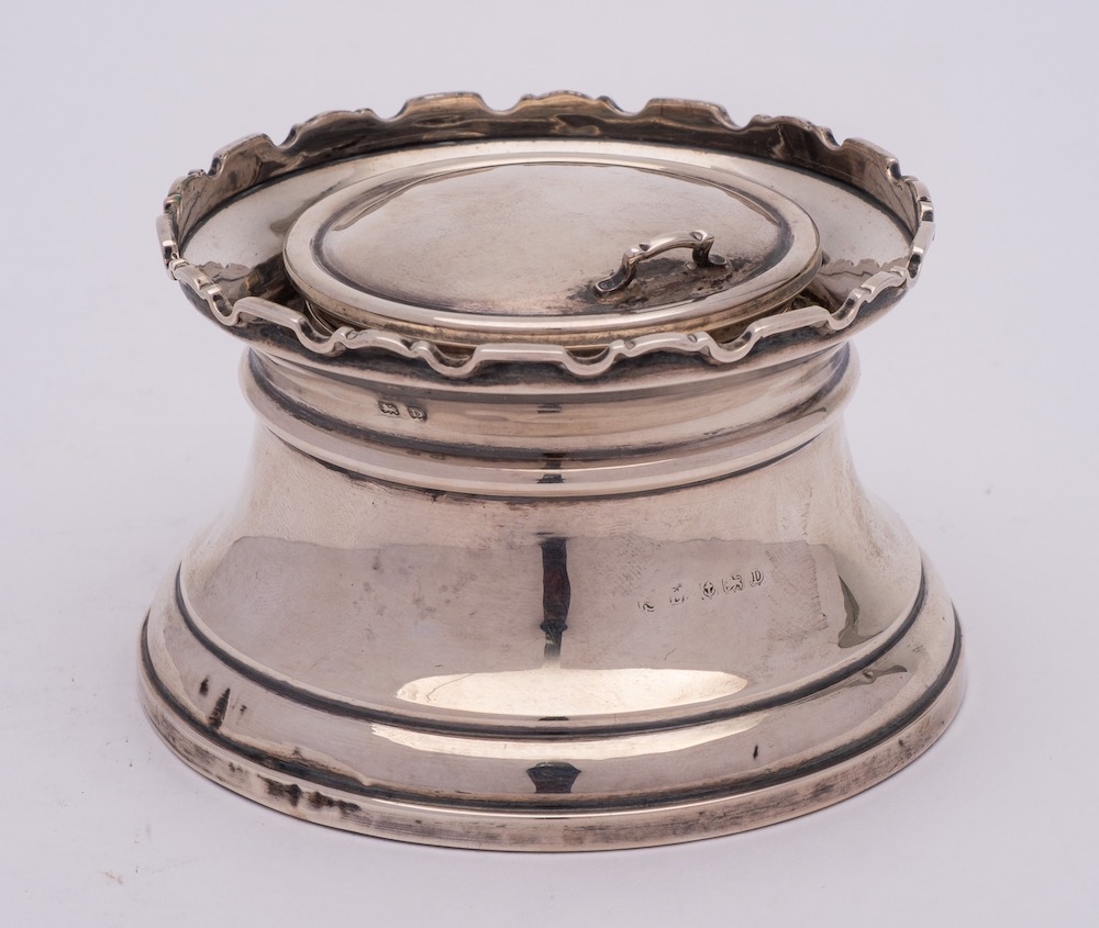 A George V silver inkwell, unknown maker, Birmingham, 1928: of circular outline,