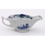 A Liverpool [William Reid] blue and white low-footed sauceboat: press-moulded and strap-fluted,