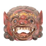 A Burmese carved wood and polychrome decorated dragon mask: of traditional design with open mouth