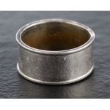 A wide band ring,: stamped 'PLAT', ring size N, width of band ca. 9mm, total weight ca. 10.2gms.