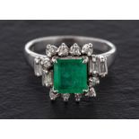 A step-cut emerald, baguette-cut and single-cut diamond cluster ring,: calculated emerald weight ca.