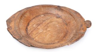 A large hardwood tribal platter: of oval outline with gadrooned rim, 59cm wide.